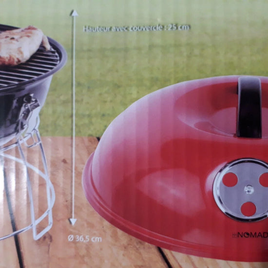 Red kettle-style grill lid with a black handle and silver control dial, shown on a wooden surface with part of a black grill and outdoor grass visible in the background. Measurement arrows and text indicate dimensions.
Be Nomad Portable Tabletop Charcoal BBQ Grill for 4 persons
