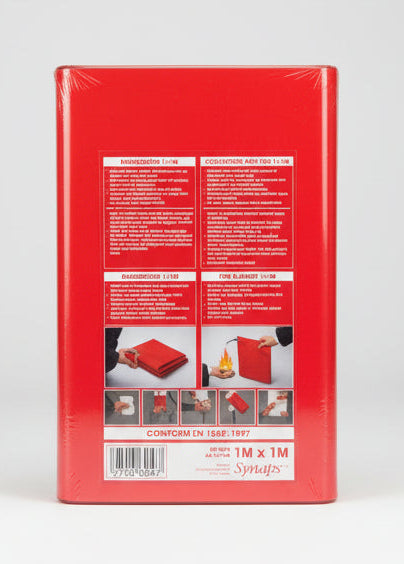 The back of a red Synaptics fire blanket package, sealed in plastic wrap and taped down with black tape, resting on a wooden desk.